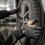 A man working on a tire in a garage